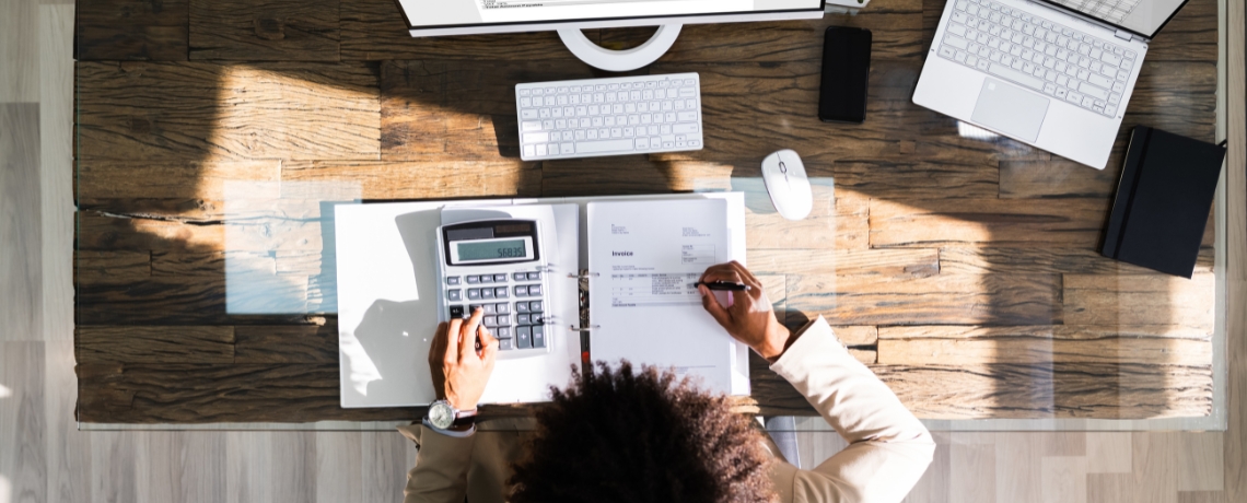 person at desk calculating finances