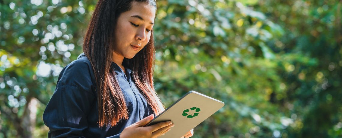 woman looking at recycled tablet